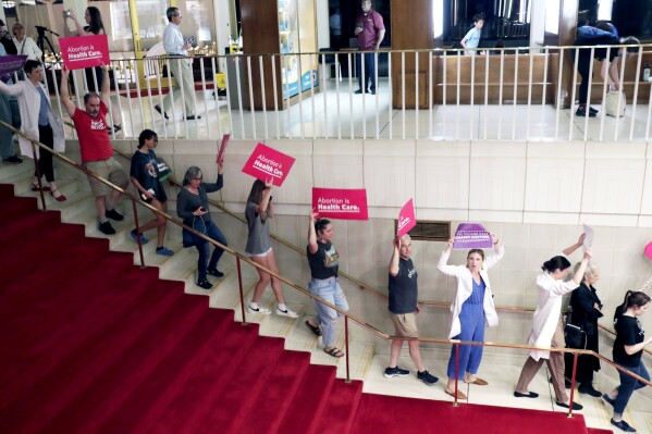 FILE - Abortion rights protesters are removed after becoming vocal, Tuesday, May 16, 2023, in Raleigh, N.C., after North Carolina House members voted to override Democratic Gov. Roy Cooper's veto of a bill that would change the state's ban on nearly all abortions from those after 20 weeks of pregnancy to those after 12 weeks of pregnancy. A federal judge on Saturday, Sept. 30, blocked two portions of North Carolina's new abortion law from taking effect while a lawsuit continues. (AP Photo/Chris Seward, File)