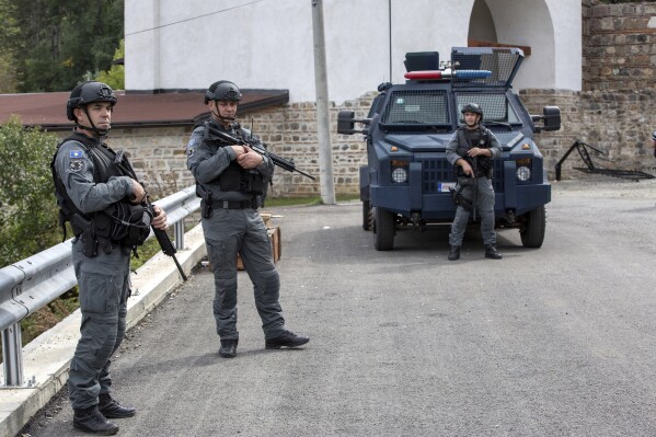 Kosovo police officers secure the area outside the Banjska monastery in the village of Banjska, Kosovo on Wednesday, Sept. 27, 2023. Police on Wednesday allowed media into the village of Banjska, where a daylong shootout between armed Serbs and Kosovar police on Sunday left one officer and three gunmen dead. (AP Photo/Visar Kryeziu)