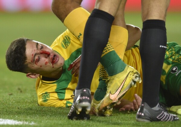 Gaston Togni of Argentina's Defensa y Justicia, lies injured on the pitch after a rough play during a Copa Sudamericana, second leg semi-final soccer match against Ecuador's Liga Deportiva Universitaria at Nestor Diaz Perez stadium in Buenos Aires, Argentina, Wednesday, Oct. 4, 2023. (AP Photo/Gustavo Garello)