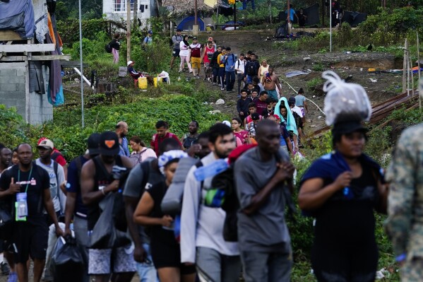 Migrants heading north line up to take a boat, in Bajo Chiquito, Darien province, Panama, Thursday, Oct. 5, 2023, after walking across the Darien Gap from Colombia. (AP Photo/Arnulfo Franco)