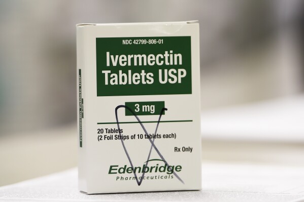 FILE - A box of ivermectin is displayed in a pharmacy Sept. 9, 2021, in Ga. Five former inmates at an Arkansas county jail have settled their lawsuit against a doctor who they said gave them the antiparasitic drug ivermectin to fight COVID-19 without their consent. (AP Photo/Mike Stewart, File)