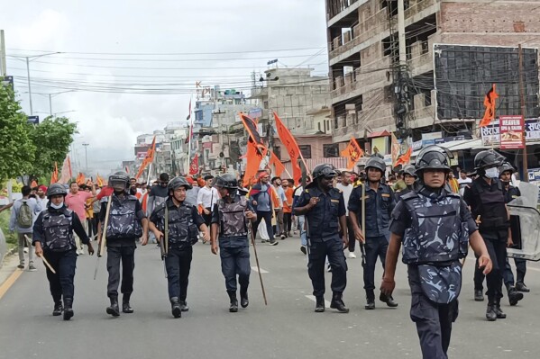 Security officers patrol during a Hindu rally in Nepalgunj, about 400 kilometers (250 miles) west of the capital, Kathmandu, Nepal, Tuesday, Oct. 3, 2023. Despite quickly escalating tensions between Hindus and Muslims, the night passed peacefully after a curfew was imposed and security heightened in a city in southwest Nepal, officials said. Communal violence is not common in Nepal, which is a Hindu majority country that turned secular just a few years ago. (AP Photo/Krishna Adhikari)