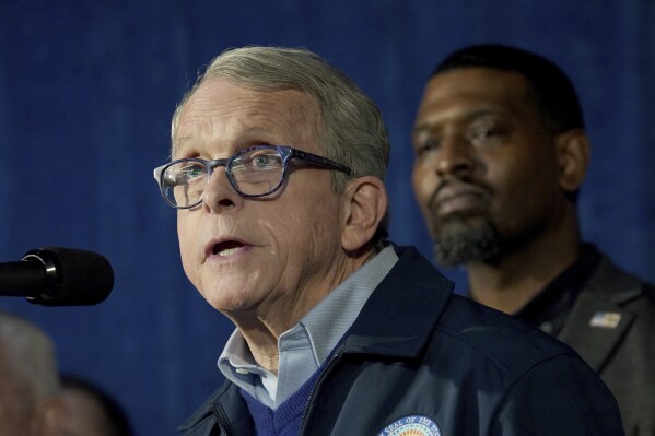 FILE - Ohio Gov. Mike DeWine speaks during a news conference, Feb. 21, 2023, in East Palestine, Ohio. At least part of a Republican-backed overhaul of the Ohio’s K-12 education system will take effect as planned, despite a court order Monday, Oct. 2, delaying the changes after a lawsuit said they violate the constitution. DeWine says that the Ohio Department of Education and Workforce will replace the Ohio Department of Education midnight Tuesday, Oct. 3, and assures that operations like school funding, employee paychecks and other functions will continue. (AP Photo/Matt Freed, File)
