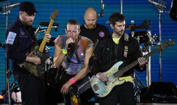 From left, Jonny Buckland, Chris Martin, Will Champion and Guy Berryman of Coldplay perform at the Rose Bowl, Saturday, Sept. 30, 2023, in Pasadena, Calif. (AP Photo/Chris Pizzello)