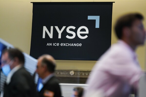 FILE - An NYSE sign is seen on the floor at the New York Stock Exchange in New York, Wednesday, June 15, 2022. (AP Photo/Seth Wenig, File)