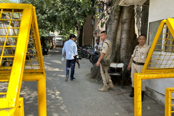 Security officers stand guard outside the office of Delhi Police's Special Cell in New Delhi, India, Tuesday, Oct. 3, 2023. Indian police raided the offices of a news website that's under investigation for receiving funds from China, as well as the homes of several of its journalists, in what critics described as an attack on one of India's few remaining independent news outlets. The raids came months after Indian authorities searched the BBC's New Delhi and Mumbai offices over accusations of tax evasion in February. (AP Photo/Piyush Nagpal)