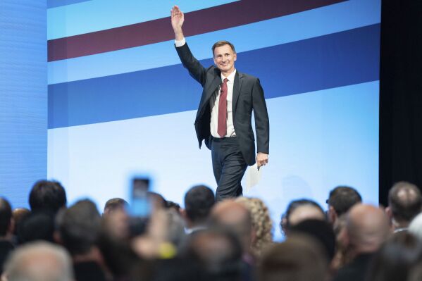 Chancellor of the Exchequer Jeremy Hunt arrives on stage to deliver his keynote speech to the Conservative Party annual conference in Manchester, England, Monday Oct. 2, 2023. (Stefan Rousseau/PA via AP)