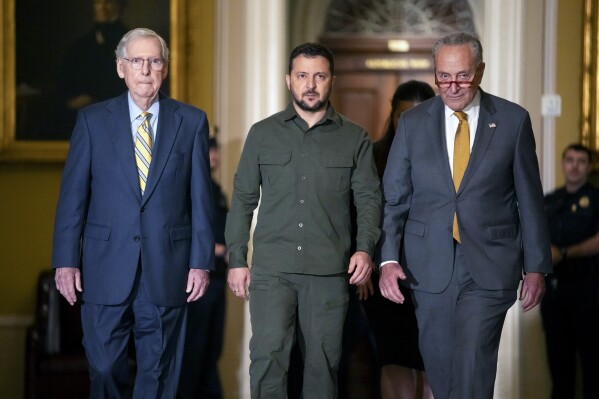 FILE - Ukrainian President Volodymyr Zelenskyy, center, walks with Senate Minority Leader Mitch McConnell of Ky., left, and Senate Majority Leader Chuck Schumer of N.Y., right, at Capitol Hill on Thursday, Sept. 21, 2023, in Washington. When U.S. lawmakers approved a spending bill Saturday, Sept. 30, that averted a widely expected government shutdown, the measure didn’t include the $6 billion in military assistance that Ukraine said it urgently needed. Now the Pentagon, White House and European allies are urging Congress to quickly reconsider. (AP Photo/Mark Schiefelbein, File)