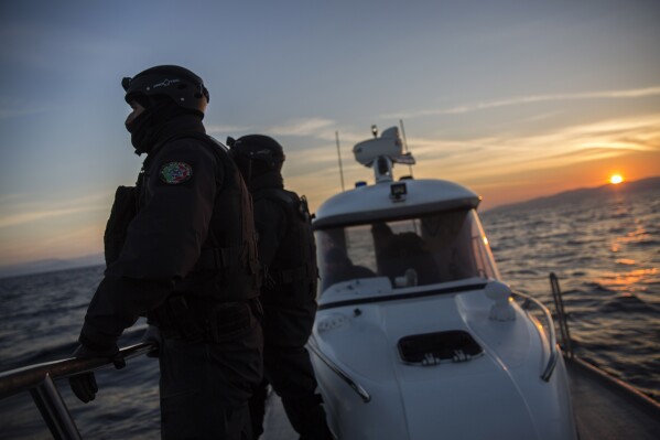 FILE - Members of the Frontex, European Border Protection Agency, from Portugal patrol as the sun rises near the northeastern Greek island of Lesbos, on Dec. 8, 2015. Dozens of migrants were rescued from a small boat in difficulty off of an eastern Aegean Sea island and a search was underway for one more person, Greek authorities said Thursday, as arrivals to the southeastern European country increase. (AP Photo/Santi Palacios, File)